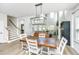 Open-concept living room with hardwood floors, staircase, fireplace, and decorative lighting fixtures at 119 Lucca Dr, Summerville, SC 29486