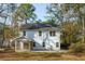 Back exterior view showcasing the screened-in porch of this two-story home with a well-maintained backyard at 1216 Ashley Hall Rd, Charleston, SC 29407