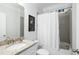 Bathroom features granite countertop, shower and tub with white shower curtain at 1216 Ashley Hall Rd, Charleston, SC 29407