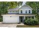 Charming light blue two-story home featuring a two-car garage and welcoming front porch at 1216 Ashley Hall Rd, Charleston, SC 29407