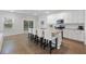 Bright kitchen features white cabinets, granite countertops, and a large island with seating at 1216 Ashley Hall Rd, Charleston, SC 29407