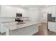 Modern kitchen island with granite countertops, stainless steel sink, and white cabinets at 1216 Ashley Hall Rd, Charleston, SC 29407