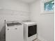 Well-lit laundry room featuring a side-by-side washer and dryer at 1216 Ashley Hall Rd, Charleston, SC 29407