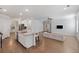 Open-concept living room with kitchen island, modern lighting, and hardwood flooring at 1216 Ashley Hall Rd, Charleston, SC 29407