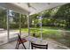 Relaxing screened porch overlooking the backyard with mature trees at 1216 Ashley Hall Rd, Charleston, SC 29407