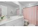 Well-lit bathroom with white cabinets, a large mirror, and a stylish shower curtain at 1226 Spotflower St, Summerville, SC 29485