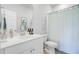 Clean bathroom with a white vanity, blue shower curtain, and coastal decor at 1226 Spotflower St, Summerville, SC 29485