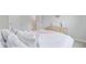 Bright bedroom with a bed with a light color scheme, showing doors and view into the hallway at 1226 Spotflower St, Summerville, SC 29485