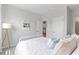 Sunlit bedroom with white linens, bedside table, and beach themed decor at 1226 Spotflower St, Summerville, SC 29485