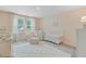 Bright Bedroom with soft pink walls, large windows, a crib, and a comfortable chair with an ottoman at 1226 Spotflower St, Summerville, SC 29485