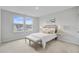 Comfortable bedroom with a neutral color palette, a bed with a tufted headboard, and two windows at 1226 Spotflower St, Summerville, SC 29485