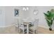 Comfortable dining room with table, six chairs, modern chandelier and beachy decor at 1226 Spotflower St, Summerville, SC 29485