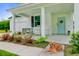 Charming front porch with swing, rocking chairs, landscaping, and a light blue door at 1226 Spotflower St, Summerville, SC 29485