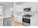 Well-lit kitchen with stainless steel appliances, white cabinets, and quartz countertops at 1226 Spotflower St, Summerville, SC 29485