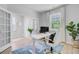 Well-lit home office with a white desk, comfortable chair, and bright natural light at 1226 Spotflower St, Summerville, SC 29485