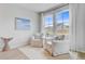 Cozy sitting room with two white armchairs, light walls, and bright windows at 1226 Spotflower St, Summerville, SC 29485