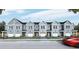 Charming row of light blue townhouses featuring individual garages and welcoming front lawns at 123 Kirkland St, Goose Creek, SC 29445