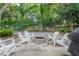 Cozy backyard featuring a stone fire pit surrounded by white rocking chairs, perfect for relaxing at 1242 Schirmer St, Mount Pleasant, SC 29464