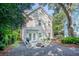 Inviting backyard with a stone fire pit, white Adirondack chairs, and lush landscaping for outdoor entertaining at 1242 Schirmer St, Mount Pleasant, SC 29464