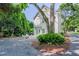 This backyard is perfect for relaxing with its fire pit, gravel bed, and surrounding trees providing privacy at 1242 Schirmer St, Mount Pleasant, SC 29464