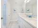 Bright bathroom featuring double sinks, white cabinets, and tiled floors at 1242 Schirmer St, Mount Pleasant, SC 29464