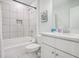 All-white bathroom with tub, shower, vanity, and tiled walls at 1242 Schirmer St, Mount Pleasant, SC 29464
