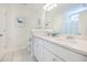 Bright bathroom featuring double sinks, white cabinets, and tiled floors at 1242 Schirmer St, Mount Pleasant, SC 29464