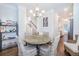 Bright dining room features a stylish chandelier, wainscoting and wood floors at 1242 Schirmer St, Mount Pleasant, SC 29464