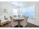 Bright dining room features a stylish chandelier, wainscoting and wood floors at 1242 Schirmer St, Mount Pleasant, SC 29464