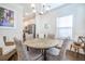 Bright dining room features a stylish chandelier, wainscoting and wood floors at 1242 Schirmer St, Mount Pleasant, SC 29464