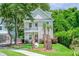 Charming two-story home with a quaint front porch and lush landscaping and palm trees in a desirable location at 1242 Schirmer St, Mount Pleasant, SC 29464