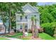 Charming two-story home with a quaint front porch and lush landscaping and palm trees in a desirable location at 1242 Schirmer St, Mount Pleasant, SC 29464