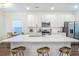 Modern kitchen with a large island, white cabinets, stainless appliances and hardwood floors at 1242 Schirmer St, Mount Pleasant, SC 29464