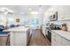 Open-concept kitchen with white cabinetry, stainless steel appliances, and hardwood floors at 1242 Schirmer St, Mount Pleasant, SC 29464