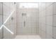A beautifully tiled glass-door shower with window and tiled soap niche at 1242 Schirmer St, Mount Pleasant, SC 29464