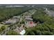 Aerial view of a community featuring a condo building, pool, and surrounding wooded areas at 1300 Park West Blvd # 106, Mount Pleasant, SC 29466