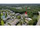 Aerial view of a residential community with multiple buildings, surrounded by lush greenery and bodies of water at 1300 Park West Blvd # 106, Mount Pleasant, SC 29466