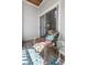 Private balcony with a single wicker chair, patterned rug, and a view towards the interior through a sliding door at 1300 Park West Blvd # 106, Mount Pleasant, SC 29466