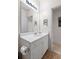 Bright bathroom with a large mirror, white vanity with storage, and neutral walls at 1300 Park West Blvd # 106, Mount Pleasant, SC 29466