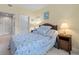 Bedroom with wood-frame bed and beach-themed decor, featuring multiple bedside tables at 1300 Park West Blvd # 106, Mount Pleasant, SC 29466