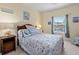 Bedroom with a large window, wood-frame bed and beach-themed decor at 1300 Park West Blvd # 106, Mount Pleasant, SC 29466