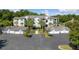 Exterior view of a lovely condo building with palm trees and multiple attached garages at 1300 Park West Blvd # 106, Mount Pleasant, SC 29466