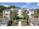 Exterior of a multi-story condominium building with well-maintained landscaping and palm trees in the foreground at 1300 Park West Blvd # 106, Mount Pleasant, SC 29466