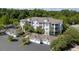 Aerial view showing a condo building with palm trees, attached garages, and lush green surroundings at 1300 Park West Blvd # 106, Mount Pleasant, SC 29466