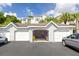 Garages with one door open showing a peek inside, revealing storage and equipment at 1300 Park West Blvd # 106, Mount Pleasant, SC 29466