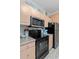 Bright kitchen with black appliances, stainless steel microwave and refrigerator at 1300 Park West Blvd # 106, Mount Pleasant, SC 29466