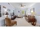 Bright living room with neutral tones, ceiling fan, comfortable seating, and balcony access at 1300 Park West Blvd # 106, Mount Pleasant, SC 29466