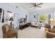 Cozy living room featuring comfortable seating, a ceiling fan, and access to a balcony at 1300 Park West Blvd # 106, Mount Pleasant, SC 29466