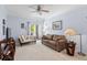Cozy living room featuring carpeted floors, comfortable seating, and access to a private balcony at 1300 Park West Blvd # 106, Mount Pleasant, SC 29466