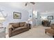 Living room with carpeted floors, comfortable sofa, view to the dining area and nautical themed decorations at 1300 Park West Blvd # 106, Mount Pleasant, SC 29466